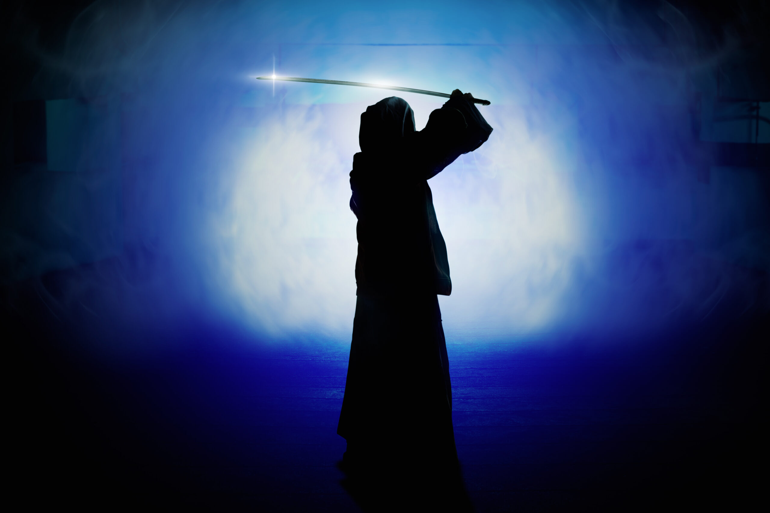 robed figure holding a laser
